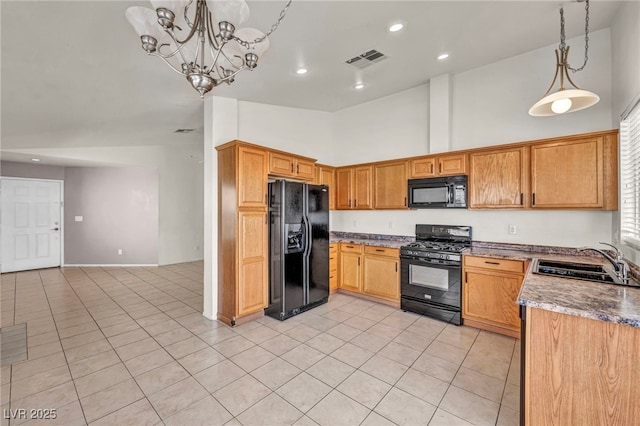 kitchen featuring visible vents, light tile patterned flooring, a sink, black appliances, and pendant lighting