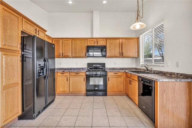 kitchen with light tile patterned floors, a high ceiling, a sink, black appliances, and dark countertops