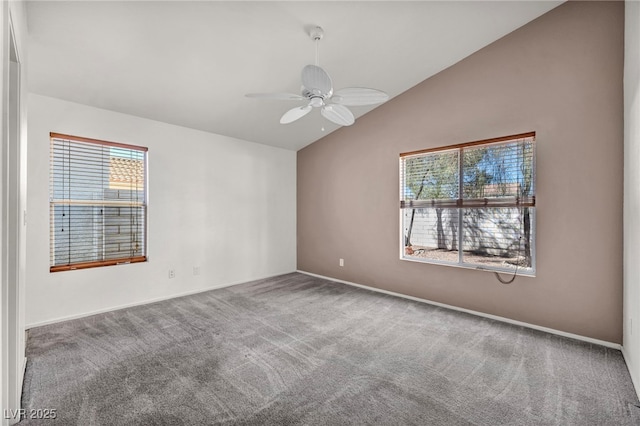 empty room featuring ceiling fan, carpet flooring, and vaulted ceiling