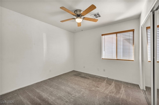 unfurnished bedroom featuring visible vents, baseboards, a ceiling fan, and carpet floors