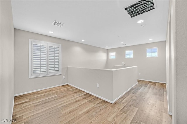 empty room with visible vents, recessed lighting, and light wood-style floors