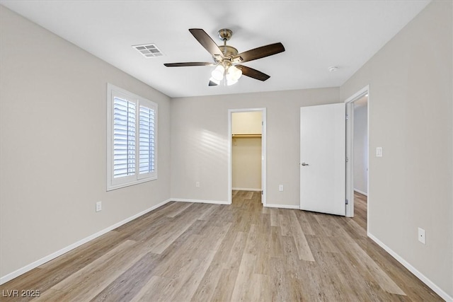 6110 Scarlet Leaf St, Las Vegas, NV 89148 - unfurnished bedroom featuring light wood-style flooring, a walk in closet, baseboards, and a closet