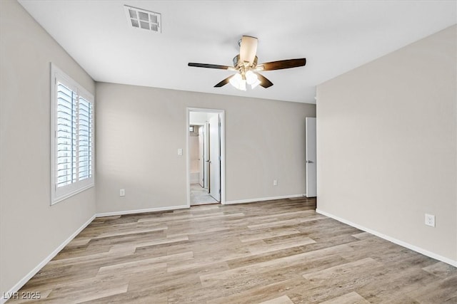 spare room with visible vents, baseboards, wood finished floors, and a ceiling fan