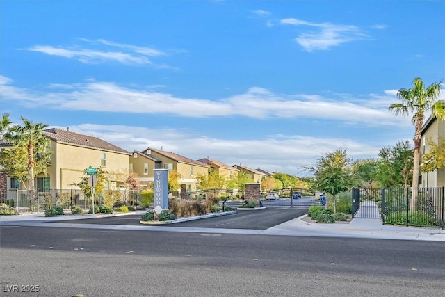 6110 Scarlet Leaf St, Las Vegas, NV 89148 - view of asphalt road featuring a residential view, sidewalks, curbs, a gate, and a gated entry
