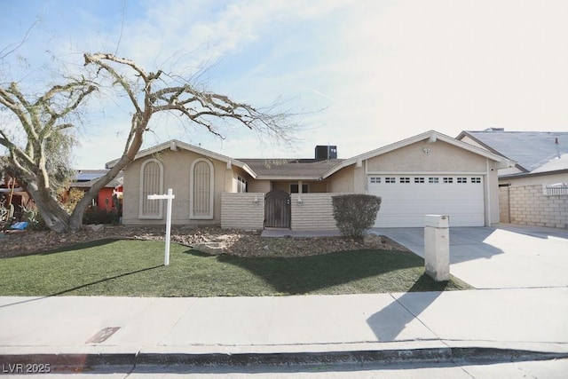 ranch-style home with stucco siding, a gate, fence, concrete driveway, and a garage