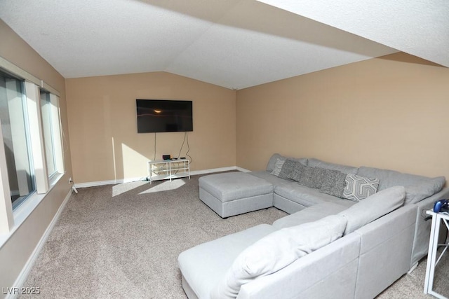 carpeted living area featuring baseboards and lofted ceiling