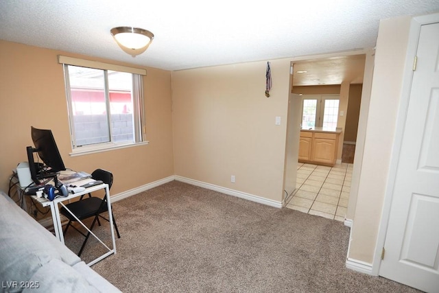 office space featuring light tile patterned floors, light colored carpet, and baseboards