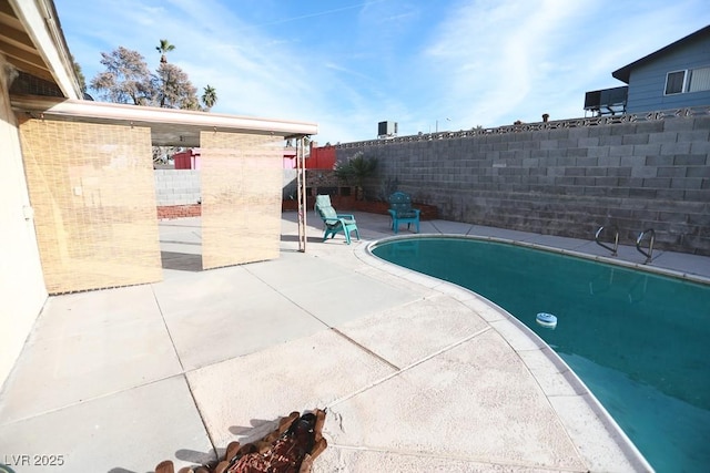 view of swimming pool with a fenced backyard, a fenced in pool, and a patio