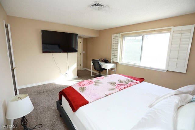 carpeted bedroom with visible vents and baseboards