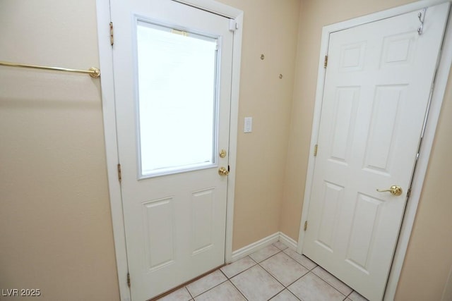 entryway featuring light tile patterned floors and baseboards