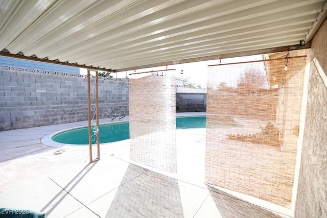 pool featuring a patio and a fenced backyard