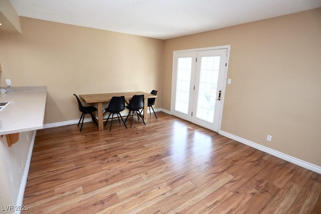 dining room with light wood finished floors and baseboards