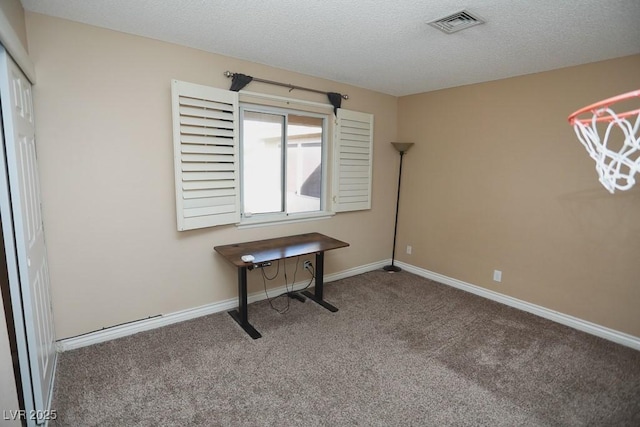 unfurnished office featuring visible vents, carpet, baseboards, and a textured ceiling