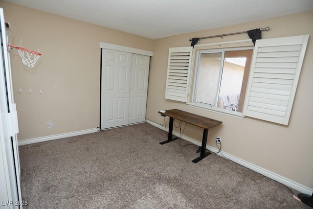 unfurnished bedroom with a closet, baseboards, and carpet