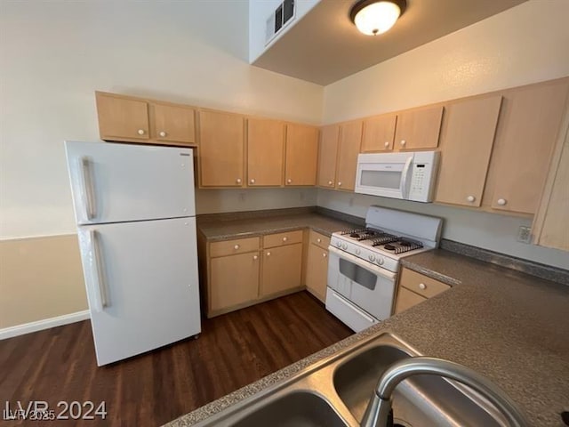 kitchen featuring visible vents, white appliances, dark countertops, and light brown cabinets