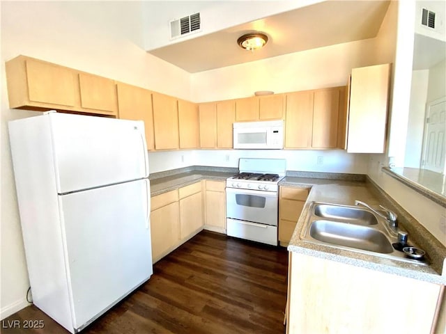 kitchen with a sink, white appliances, visible vents, and light brown cabinetry