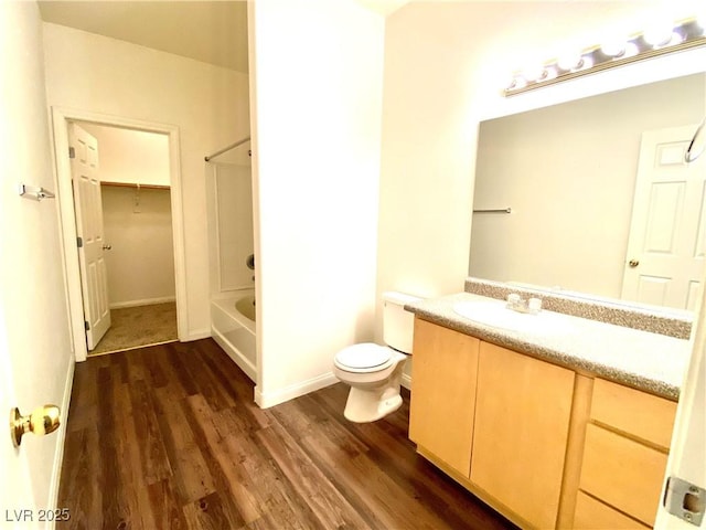 full bathroom featuring vanity, shower / tub combination, toilet, and wood finished floors