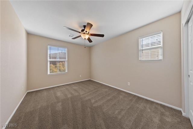 unfurnished room featuring visible vents, baseboards, carpet, and a ceiling fan