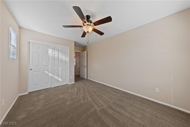 unfurnished bedroom featuring a closet, baseboards, carpet, and a ceiling fan