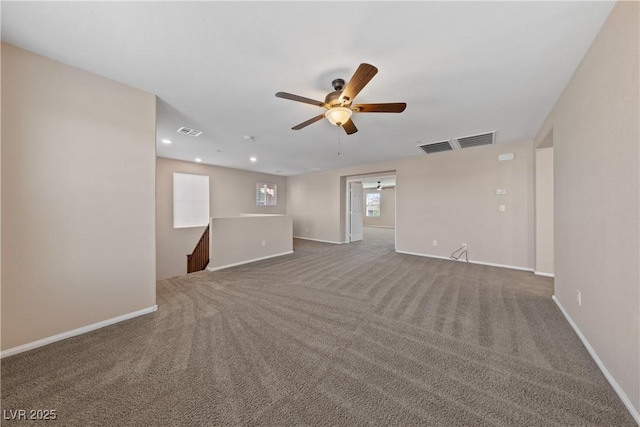 carpeted empty room featuring visible vents, recessed lighting, a ceiling fan, and baseboards