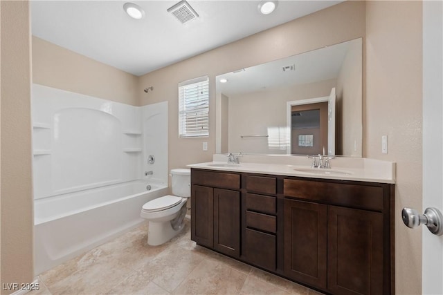 full bath with double vanity, visible vents, toilet, and a sink