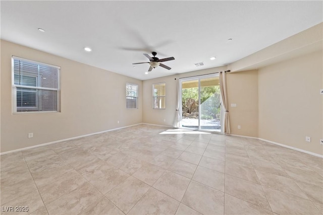 spare room featuring light tile patterned floors, visible vents, baseboards, and a ceiling fan