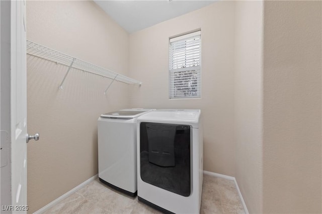 laundry room with laundry area, washer and dryer, and baseboards