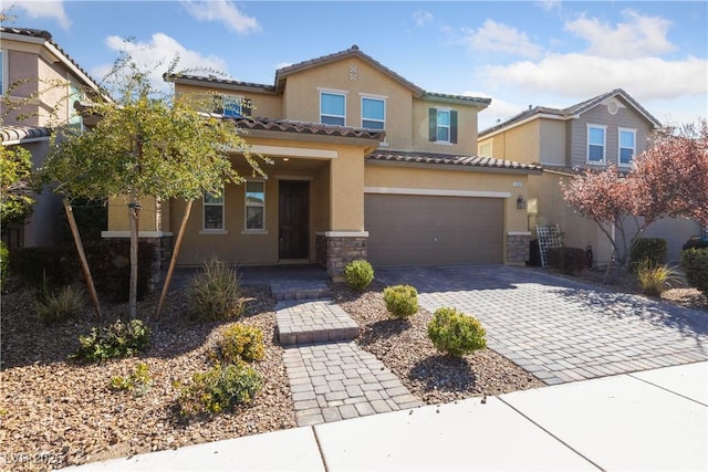 view of front facade featuring stone siding, stucco siding, decorative driveway, and a garage