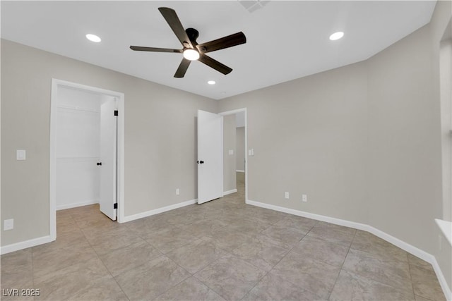 unfurnished bedroom featuring a spacious closet, recessed lighting, baseboards, and ceiling fan