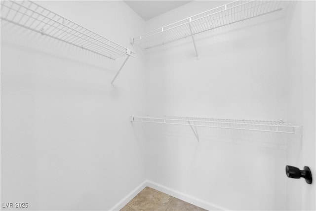 walk in closet featuring light tile patterned floors