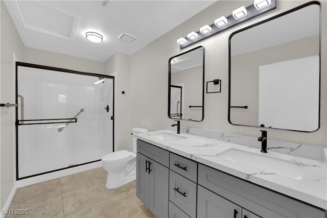 bathroom with a sink, toilet, double vanity, and a shower stall