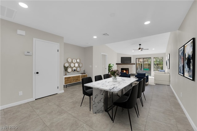 dining space with a fireplace, recessed lighting, visible vents, and baseboards