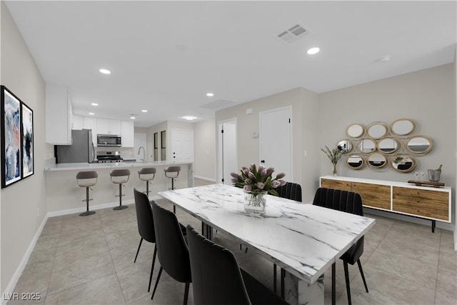 dining area featuring light tile patterned floors, visible vents, recessed lighting, and baseboards