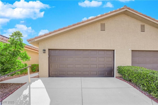 garage featuring driveway