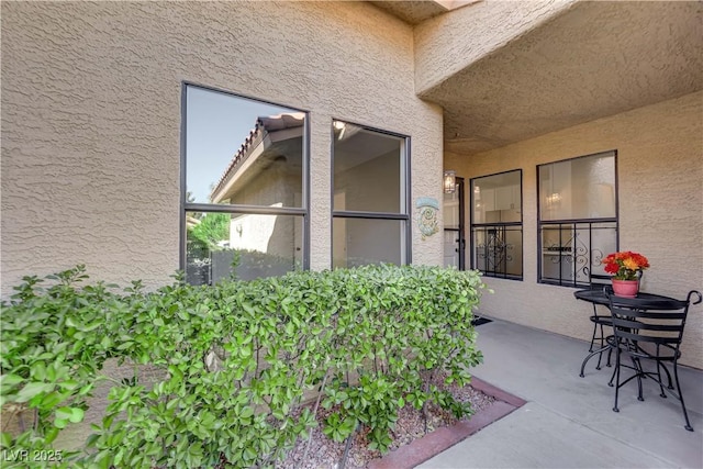 exterior space featuring stucco siding and a patio area