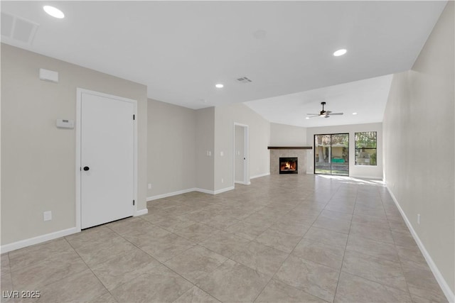 unfurnished living room featuring visible vents, recessed lighting, baseboards, ceiling fan, and a tile fireplace