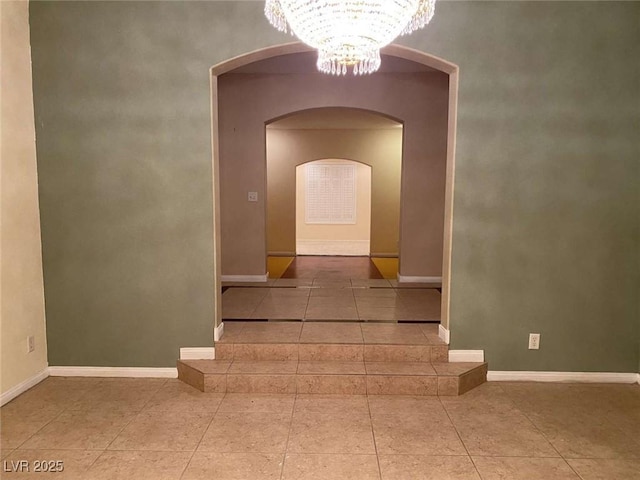 9301 Harrow Rock St, Las Vegas, NV 89143 - staircase with a chandelier, arched walkways, baseboards, and tile patterned floors