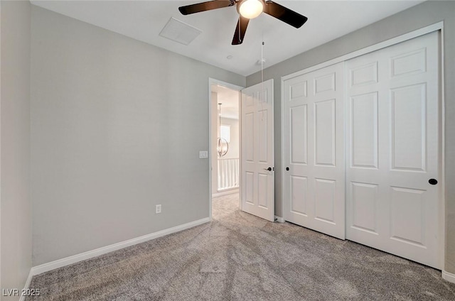 unfurnished bedroom with a closet, baseboards, ceiling fan, and carpet flooring