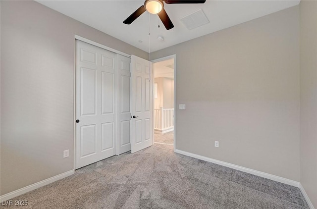 unfurnished bedroom with a closet, a ceiling fan, baseboards, and carpet floors