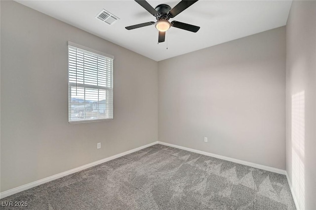 spare room with a ceiling fan, carpet, visible vents, and baseboards