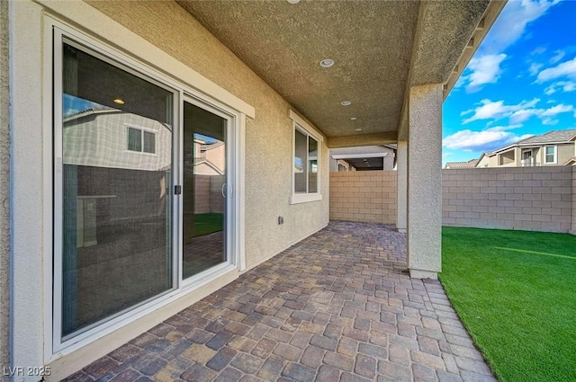 view of patio / terrace featuring fence