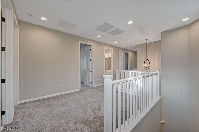 hallway featuring recessed lighting, an upstairs landing, carpet, and an inviting chandelier