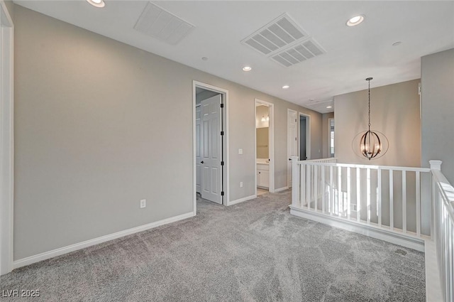 carpeted spare room featuring a chandelier, visible vents, recessed lighting, and baseboards