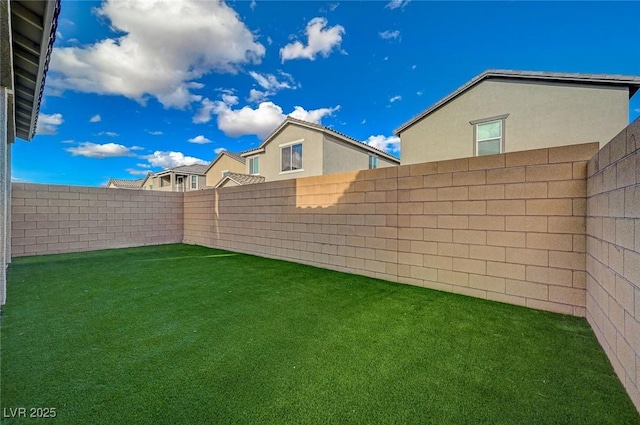 view of yard with a fenced backyard