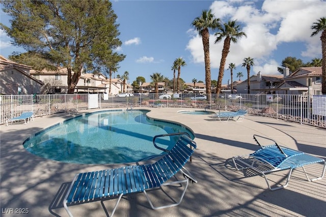 pool featuring a patio area, a residential view, and fence