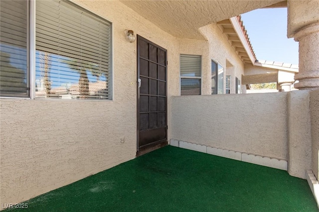 view of exterior entry featuring stucco siding