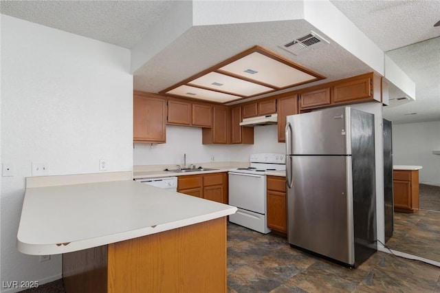 kitchen with white appliances, visible vents, a peninsula, a sink, and under cabinet range hood