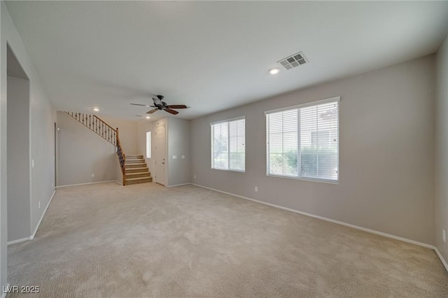 8348 Mokena Ave, Las Vegas, NV 89178 - unfurnished living room featuring baseboards, stairs, light colored carpet, a ceiling fan, and recessed lighting