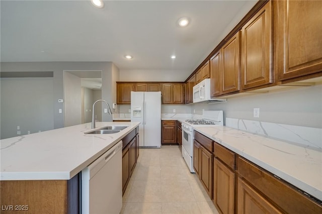 8348 Mokena Ave, Las Vegas, NV 89178 - kitchen featuring white appliances, a sink, brown cabinets, recessed lighting, and light tile patterned floors