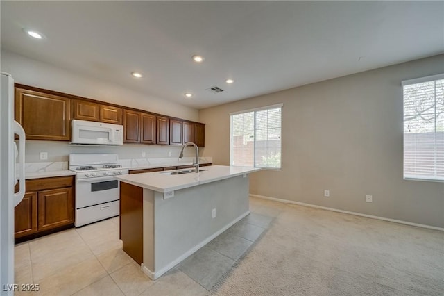 8348 Mokena Ave, Las Vegas, NV 89178 - kitchen featuring white appliances, a sink, a center island with sink, plenty of natural light, and recessed lighting